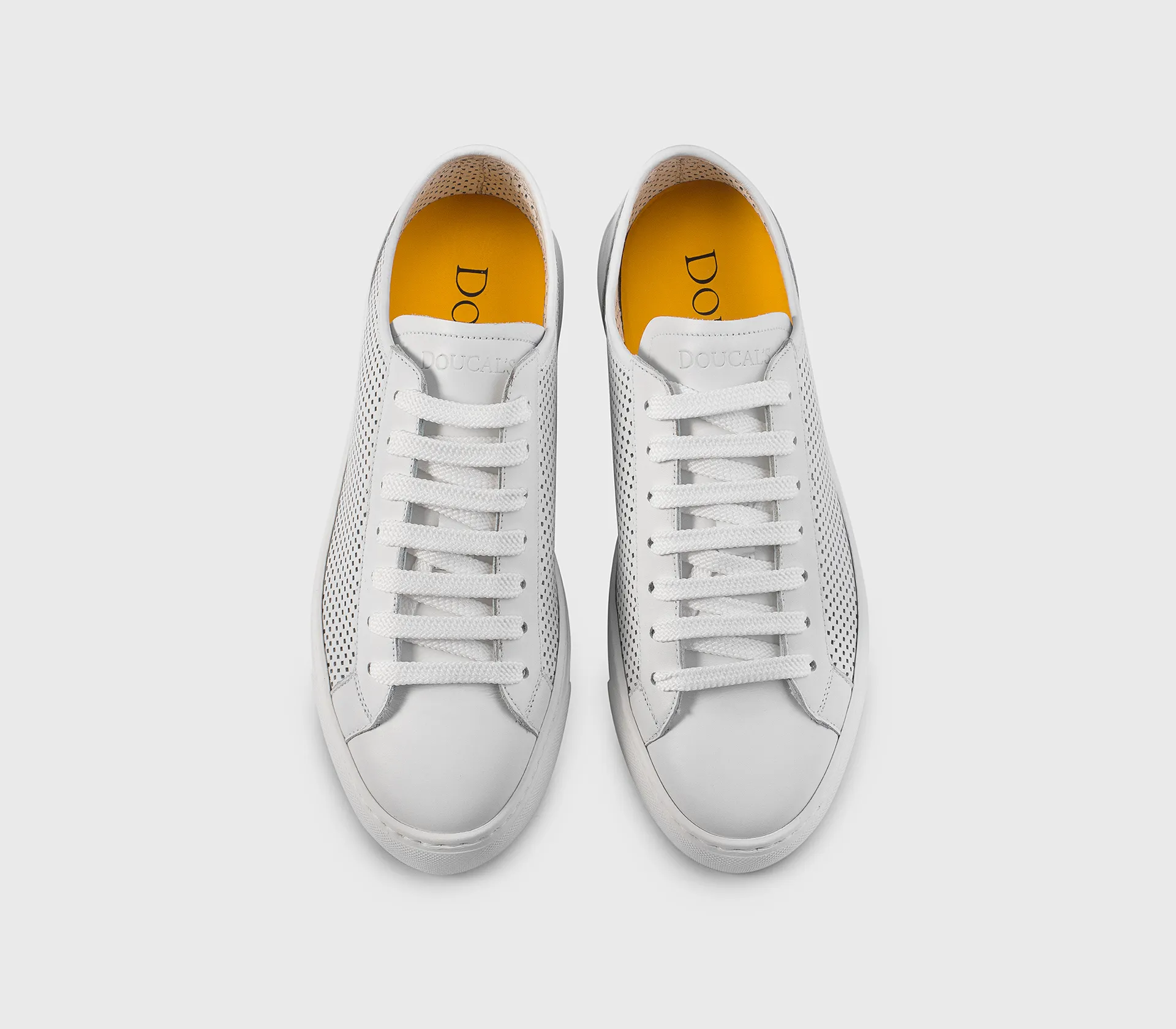 Sneaker in white perforated leather